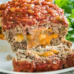 meatloaf with cheese and sauce on a white plate