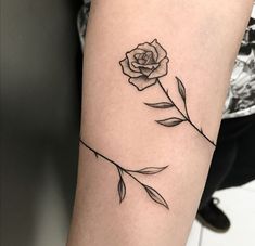 a single rose tattoo on the arm