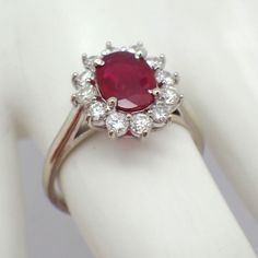 Vintage 14k (.585) white gold ring, having oval-cut Natural Ruby centerpiece accompanied by Diamond halo.  This majestic ring is a size 8, it is 14 mm at the widest, weighing 3.8 grams. The Ruby measures 8.62 mm x 6.4 mm x 2.15 mm, approx. 0.85ct. 12 Diamonds are approx. 0.4ctw, SI clarity, color G-H. EA3969 Gia Certified Oval Ruby Ring, Formal Oval Ruby Ring In Platinum, Oval Ruby Ring In Platinum For Formal Occasions, Oval Ruby Ring In Platinum For Anniversary, Oval Ruby Ring With Platinum Band, Oval Ruby Ring With Platinum Center Stone, Oval Ruby Ring With Platinum, Oval Ruby Ring With Platinum Setting, Oval Platinum Halo Ring With Gemstone