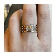 a woman's hand with a gold and white diamond ring on her left hand