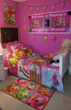 a bedroom with pink walls and lots of stuffed animals on the bed in front of it