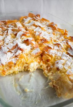 a casserole dish with powdered sugar on top