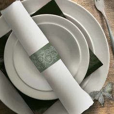 the place setting is set with green napkins and white plates