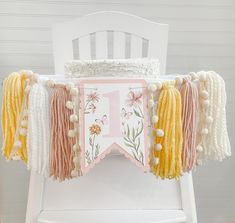 a white chair with some tassels on it