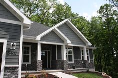 a house with gray siding and white trim