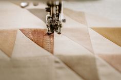 the sewing machine is stitching fabric together