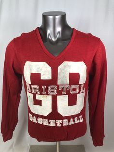 a red shirt with the number 69 on it is sitting on a mannequin