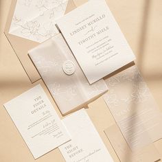 the wedding stationery is laid out on top of each other