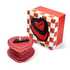 a heart shaped cake in front of a box