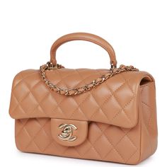 This Chanel Mini Rectangular flap bag with top handle is of caramel quilted lambskin leather with light gold tone hardware, front flap with CC turnlock closure, half moon back pocket and interwoven light gold tone chain link and Caramel shoulder/crossbody strap. The interior is lined in caramel leather and features one zip pocket on the rear wall with logo pull and one open pocket on the rear wall underneath zip pocket. Collection: 23P (RFID chip) Origin: Italy Condition: Pristine; new or never Chanel Mini Rectangular, Chanel Classic Flap Bag, Chanel Box, Classic Flap Bag, Chanel Mini, Gold Chanel, Lk Bennett, Pierre Hardy, Rene Caovilla