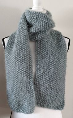 a gray knitted scarf on a mannequin