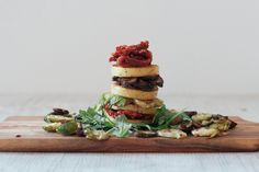 a stack of food sitting on top of a wooden cutting board