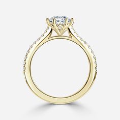 a yellow gold engagement ring with diamonds on the side