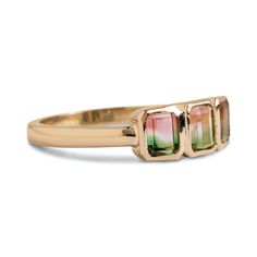 DETAILS Metal - 14k yellow gold Stone(s) - 1.50tcw emerald cut watermelon tourmaline Band width - 2.4mm WHY WE LOVE IT Lucky number three. ﻿This gemstone ring features a 1.50tcw of three petite emerald cut watermelon tourmalines set in a row and all bezel set in 14k yellow gold. This stunner is your next go-to everyday statement ring, easily worn stacked or solo! SHIPPING + RETURNS Currently sized at a 7, please allow 2 weeks for additional sizing and shipping. Learn about our Return + Exchange Yellow Gold Tourmaline Emerald-cut Ring, Watermelon Tourmaline Engagement Ring, Tourmaline Engagement Ring, Cut Watermelon, Number Three, Lucky Number, Ring Sale, Gifts For My Wife, Gold Stone