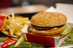 a hamburger and french fries are sitting on a tray at a fast food restaurant, ready to be eaten