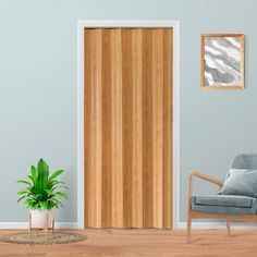 a living room with a chair, potted plant and wooden door