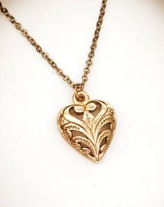 Necklace.  New 1970s vintage 14k gold plated heart pendant.  Scroll design.  Beautiful gift for the Elegant Heart Pendant Necklace With Vintage Charm, Heart-shaped Gold Jewelry With Vintage Charm, Elegant Brass Heart Necklace, Elegant Heart Necklace With Vintage Charm As Gift, Elegant Heart-shaped Brass Necklace, Vintage Charm Heart Pendant Necklace For Anniversary, Dainty Necklace With Vintage Heart Pendant, Dainty Heart Pendant Jewelry With Vintage Charm, Dainty Necklace With Heart Pendant And Vintage Charm