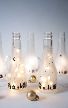 some bottles with lights in them on a table