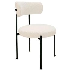 a white chair sitting on top of a black metal frame with a sheepskin seat