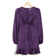 a purple dress hanging on a hanger