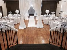 an indoor wedding venue with white decorations