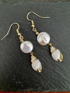 These beautiful earrings are made from real gold plated seashells and Baroque Pearls. The seashells are around 18mm long, Baroque Pearl  12mm, ear-wires are gold filled. Each item is carefully packaged in a beautiful jewellery box ready as a gift. If you would like to add a personalized note with your order, just write a note at checkout and I will send a small card with your gift to the recipient. If you need a bigger quantity or any customized jewellery for your very special occasion (birthdays, weddings, bridal showers or any other event), please send me a message and I'll be glad to help. Elegant Shell Dangle Earrings, Elegant Dangle Shell Earrings, Shell-shaped Yellow Gold Earrings Gift, Elegant Shell Pearl Earrings, Elegant Shell Pearl Earrings For Pierced Ears, Yellow Gold Shell-shaped Earrings Gift, Shell-shaped Yellow Gold Earrings For Gifts, Elegant Dangle Shell, Elegant Pearl Drop Earrings For Beach