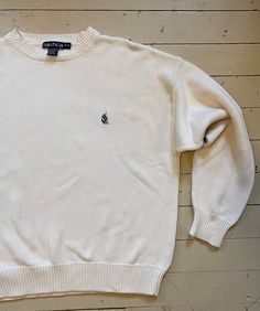 Classic 90s Nautica white cotton pullover sweater. Boxy fit. In excellent vintage condition. Marked a medium, please see measurements. All taken flat. Double where appropriate.  Shoulder 25" Chest 23" Sleeve from pit 22" Length 25" Vintage White Sweater With Ribbed Cuffs, White Cotton Polo Sweater With Ribbed Cuffs, Vintage Cotton Polo Sweater With Crew Neck, Vintage Cotton Crew Neck Polo Sweater, Classic White Crew Neck Sweater, White Crew Neck Polo Sweater Casual, Casual Cream Crew Neck Polo Sweater, Sweater White, Cotton Pullover