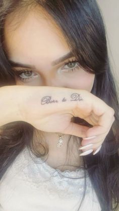 a close up of a person with a tattoo on her hand and the words, love is