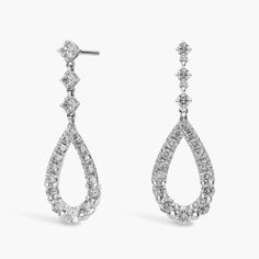 pair of diamond earrings on white background with clipping for use in jewelry design and packaging