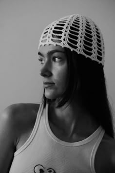 a woman wearing a white crocheted hat