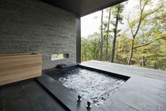 an outdoor jacuzzi tub in the middle of a room