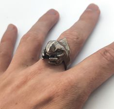 a person's hand with a silver ring on it