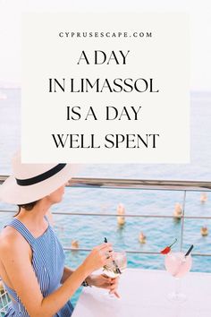 a woman sitting at a table with a drink in her hand and the words, a day in limasso is a day well spent