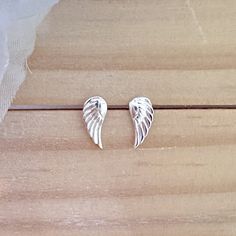 925 Sterling silver angel wing stud earrings.  Each wing shaped earring showcases sculpted feather details. Angel wings are very special as it is a symbol of angels who symbolize protection, purity, courage, love and harmony. Earrings are perfect for any age. Sold as a pair. Metal : 925 Sterling Silver. ( 925 stamped ) Finishing: 925 Sterling silver. Measurements : 5mm x 12mm. Sold as pair. These delicate stud earrings are handcrafted from 925 sterling silver, that doesn't tarnish your ears, hypoallergenic, nickel and lead free. ADD TO YOUR ORDER: 925 Sterling silver butterfly silicone coated backings link:  https://www.etsy.com/listing/1329998079/hypoallergenic-925-sterling-silver?click_key=4f118e1c6fc0ffc59ced3828b98795b9ea8b113d%3A1329998079&click_sum=de83cded&ref=shop_home_active_56&st Elegant Winged Earrings For Gift, Sterling Silver Winged Earrings Gift, Winged Sterling Silver Earrings For Gift, Winged Sterling Silver Earrings As Gift, Winged Sterling Silver Earrings In Silver, Silver Sterling Silver Winged Earrings, Silver Winged Sterling Silver Earrings, Silver Angel Wings Elegant Earrings, Elegant Angel Wings Earrings As Gift