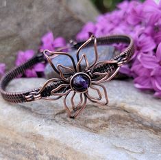 This bracelet is lovingly handcrafted with woven, antiqued and hand polished copper wire.  It will arrive gift boxed and ready for giving.  This bracelet measures 6.5 inches.  Amethyst can be used to simulate the crown or third eye chakra.  It clears negative thinking to create emotional balance and it promotes a higher understanding of ourselves and the world around us. Because of its ability to promote higher thinking, amethyst stimulates creativity and passion. Wire Wrapped Copper Wire Cuff Bracelet Gift, Unique Copper Wire Cuff Bracelet Gift, Bronze Hand Wrapped Cuff Bracelet Gift, Bronze Hand Wrapped Cuff Bracelet For Gift, Hand Wrapped Copper Cuff Bracelet Gift, Spiritual Copper Cuff Bracelet As Gift, Spiritual Copper Cuff Bracelet For Gift, Spiritual Hand Forged Cuff Bracelet Gift, Adjustable Copper Flower Jewelry