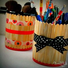 two wooden pencils with bows and polka dots on them are sitting next to each other