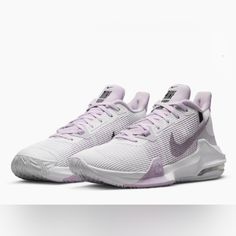 a pair of white and purple sneakers