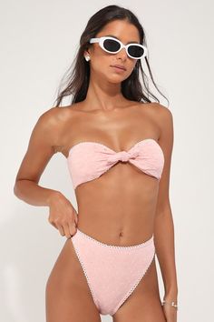 The Dippin' Daisy's Bunny Light Pink Eyelet Tie-Front Strapless Bandeau Bikini Top is the sweetest summer look you'll ever see! Sleek and stretchy tricot knit, with lace-lace eyelet embroidery, shapes a tie-front silhouette that forms a strapless bandeau-style bikini top. White looped trim, supportive side boning, and removable padding. Fit: This garment fits true to size. Length: Size medium measures 5.5" from top to bottom. Bust: Works best for A to C cup sizes. Fabric: Fabric is very stretchy Chic Summer Swimming Tube Top, Chic Strapless Swimwear For Beach Season, Chic Tube Top For Poolside And Beach Season, Strapless Summer Tube Top For Sunbathing, Strapless Tube Top For Summer Sunbathing, Strapless Tube Top For Sunbathing, Strapless Tube Top For Sunbathing In Summer, Chic Summer Tube Top For Poolside, Strapless Tube Top For Swimming In Spring