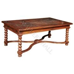 an old wooden coffee table with carved legs