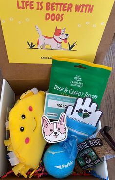 the dog box is filled with treats, toys and other things to be given as gifts