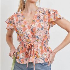 This Colorful Floral Top Has A Very Lovely Tiered Flutter Short Sleeves. It Features A Wrap Style Neckline And Tie Details Around The Waist. It Surely Makes Very Beautiful Outfit And Vacation Ready. *True To Size* Cinched Elastic Waistband Unlined Fabric: 100% Polyester Care: Machine Wash Cold On Gently, Lay Flat To Dry X-Small: Bust: 30-34" // Length: 20" Small: Bust: 32-36" // Length: 21" Medium: Bust: 34-38" // Length: 22" Large: Bust: 36-40" // Length: 23" ** Length Measurements Are Taken Fr Spring V-neck Top With Elastic Waistband, Feminine Floral Print Top With Butterfly Sleeves, Feminine Floral Print Tops With Butterfly Sleeves, Spring Tops With Smocked Back And Flutter Sleeve, Flutter Sleeve Tops With Smocked Back For Spring, Spring Flutter Sleeve Blouse With Smocked Back, Spring Blouse With Smocked Back And Flutter Sleeve, Spring V-neck Blouse With Elastic Waistband, Chic Blouse With Elastic Waistband For Spring