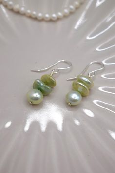 Introducing our "Green Harmony Pearl Earrings," a beautiful pair of earrings featuring one AA 6-7mm green potato near-round freshwater pearl with two AAA 6-8mm Green Keshi freshwater pearls on top, elegantly suspended from sterling silver hooks. These earrings are a celebration of the harmonious blend of different pearl shapes and shades of green, perfect for those who appreciate unique and nature-inspired jewellery. Each earring showcases a lustrous green potato pearl at the bottom, known for i Green Potatoes, Nature Inspired Jewelry, Keshi Pearls, Pearl Size, Shades Of Green, Nature Inspired, Freshwater Pearls, Everyday Fashion, Jewelry Earrings Dangle