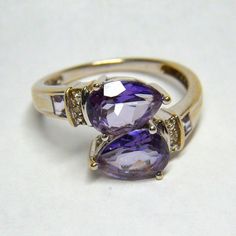 Vintage 14k Pale Gold & Amethyst Pear Ring Size 7 The ring features two pear-shaped amethysts and two square-shaped amethysts. The ring is marked  "14K" on the band's inverse. The stones are in excellent condition as examined with a R. Rubin 18mm-10x Triplet jeweler's loupe. The piece has been stored in an estate in Hillsborough, California, for the past 40 years. Weight: 5 grams. Size:  7 Purple Teardrop Amethyst Ring For Anniversary, Fine Jewelry Teardrop Purple Ring, Fine Jewelry Purple Teardrop Ring, Purple Teardrop Fine Jewelry Ring, Pear-shaped Amethyst Rings With Accent Stones, Pear-shaped Purple Jewelry For Anniversary, Purple Pear-shaped Jewelry For Anniversary, Fine Jewelry Purple Pear-shaped Jewelry, Classic Pear-shaped Purple Jewelry