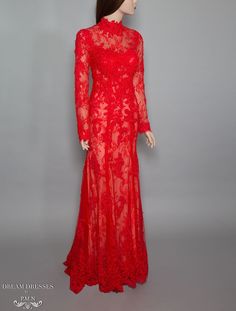 Red gown in beaded lace Tall collar Long sleeves Sheath silhouette Sweep train Closure: buttons and hidden zip back Materials: Chantilly lace, Alencon lace, tall lace trim, tulle, silk crepe, beads Dry clean only Lace Long Sleeve Evening Dress For Gala, Elegant Long Sleeve Gown With Lace Sleeves For Gala, Long Sleeve Scalloped Lace Dress For Gala, Scalloped Lace Long Sleeve Dress For Gala, Long Sleeve Lace Gown With Sweep Train, Evening Gown With Scalloped Lace And Long Sleeves, Red Long Sleeve Evening Dress For Wedding, Red Wedding Gown With Lace Bodice, Formal Long Sleeve Lace Gown