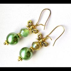 Dainty Handmade Earrings Feature Glass Pearls (11mm) In Pear Green Color Paired With Half Green/Half Metallic Gold Faceted Glass Beads Topped With A Gold Tone Bow Knot. Length Including Kidney Ear Wires 1.75”. Christmas Gold Beaded Earrings, Elegant Beaded Earrings As Christmas Gift, Elegant Beaded Earrings For Christmas Gift, Elegant Green Earrings For Christmas, Gold Beaded Earrings For Holiday, Handmade Elegant Beaded Earrings For Christmas, Elegant Beaded Christmas Earrings, Elegant Beaded Earrings For Christmas, Elegant Beaded Earrings For Holiday