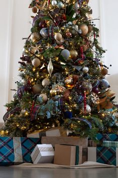 a decorated christmas tree with presents under it