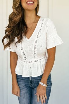 Get ready to bloom in the Madelyn Eyelet Peplum Top! This off-white top features delicate eyelet floral details and a stretchy elastic waist in the back for a comfortable fit. The open back with tie adds a flirty touch to complete the look. Perfect for any spring or summer occasion! Fits true to size Model is 5'10", is a 34D, dress size 4/5 and wearing a size small Layered Sweater, White Top, White Tops, Long Tops, Dress Accessories, Denim Pants, Peplum Top, Open Back, Elastic Waist