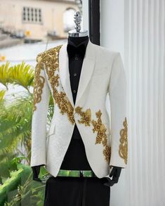 Make a statement in this Bespoke exquisitely crafted white tuxedo jacket. This jacket is perfect for any special occasion, from a wedding to a black-tie gala. It features a classic, tailored fit with a sleek, modern silhouette. The jacket is crafted from high-quality, luxurious fabric and is adorned with intricate golden beading and gems details. The jacket is fully lined and has a single button closure. The jacket comes with a matching pocket square and is a must-have for any man's wardrobe. Cu Luxury Men's Tuxedo With Lapel Collar, Designer Luxury Tuxedo For Black-tie Events, Luxury Gentleman Tuxedo With Ties, Luxury Brocade Men's Tuxedo, Luxury Men's Tuxedo Dress Shirt, Luxury Men's Tuxedo For Party, Luxury Men's Suit For Costume Party, Luxury Cream Tuxedo For Semi-formal Events, Luxury Gentleman's Tuxedo For Business