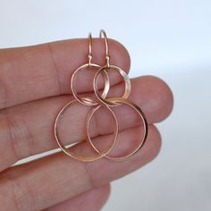 "Rose gold ribbon double hoop earrings. The rose gold has been hand forged and shaped to give them an organic feel. The hammered hoops hang from handmade ball end ear wires. The earrings in the photos have been given a brushed satin finish, but you can also choose shiny at checkout. Classic design with a twist, perfect for every occasion. Earring Length - Approximately 1 3/4\"L **Also available in 14k and 18k yellow gold. To purchase yellow gold go to this listing: https://www.etsy.com/listing/1 Elegant Hammered Rose Gold Hoop Earrings, Handmade Rose Gold Hoop Earrings For Anniversary, Hammered Rose Gold Hoop Earrings Gift, Gold Circle Earrings, Rose Gold Ribbon, Ribbon Earrings, Rose Gold Circle, Hoop Dangle Earrings, Double Hoop Earrings