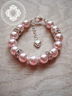 Swarovski Pink Pearl bracelet The perfect little gift for a baptism, blessing, Christening, baby shower, Flower girl, Communion, birthday, or just because! The SWAROVSKI Pearl baptism bracelet is handmade and custom designed for your special baby girl.The bracelet is made with high Infant Jewelry, Baptism Bracelet, Bead Accessories, Pink Pearl Bracelet, Beautiful Beaded Jewelry, Baby Pearls, Baby Bracelet